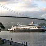 Cruise Ship sails under Lions Gate Bridge, Vancouver at sundown